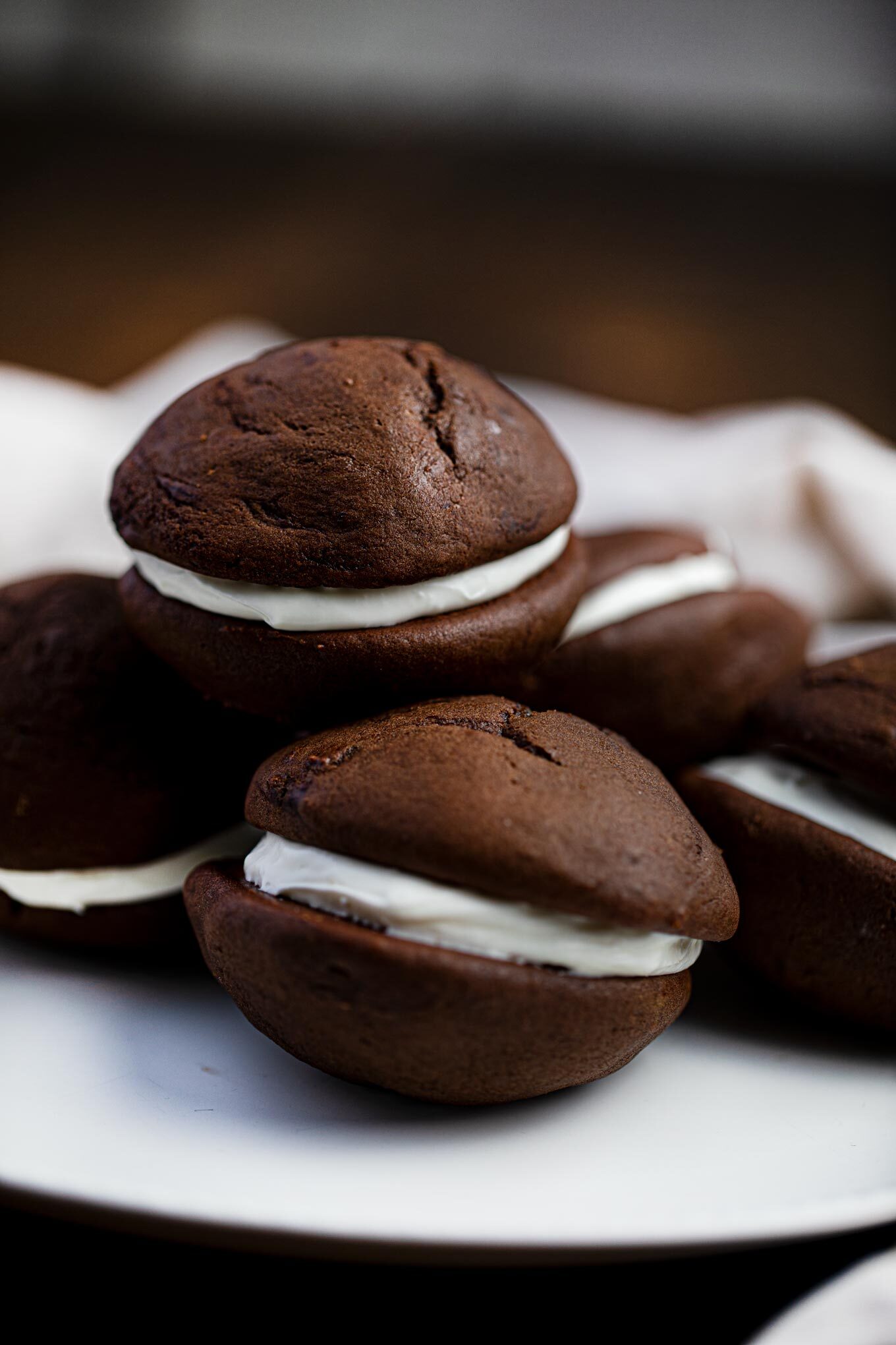 Plate full of chocolate whoopie pies with marshmallow fluff filling