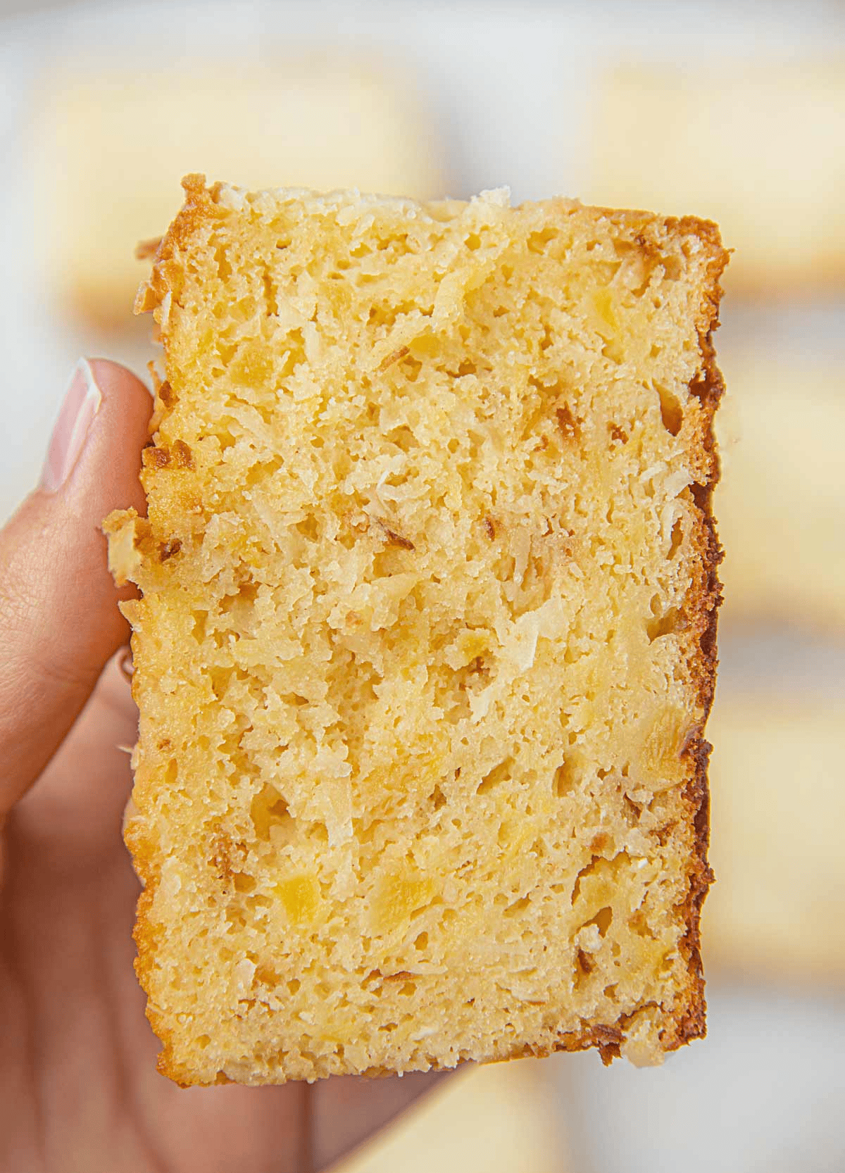 Hand holding a slice of quick bread