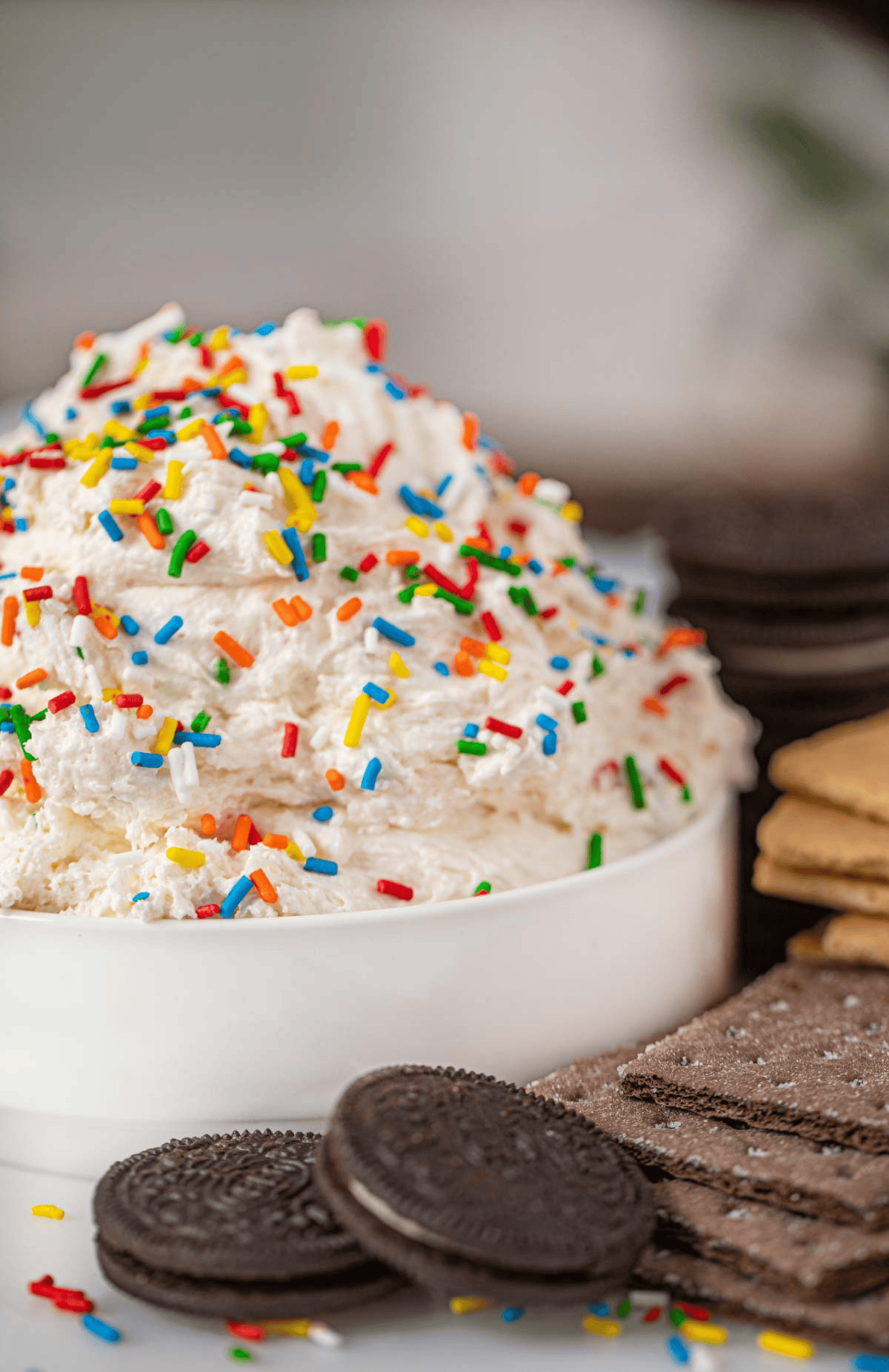Oreos and graham crackers next to cake dip