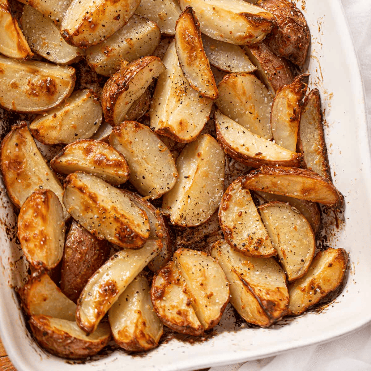 Seasoned red potatoes in a white pan