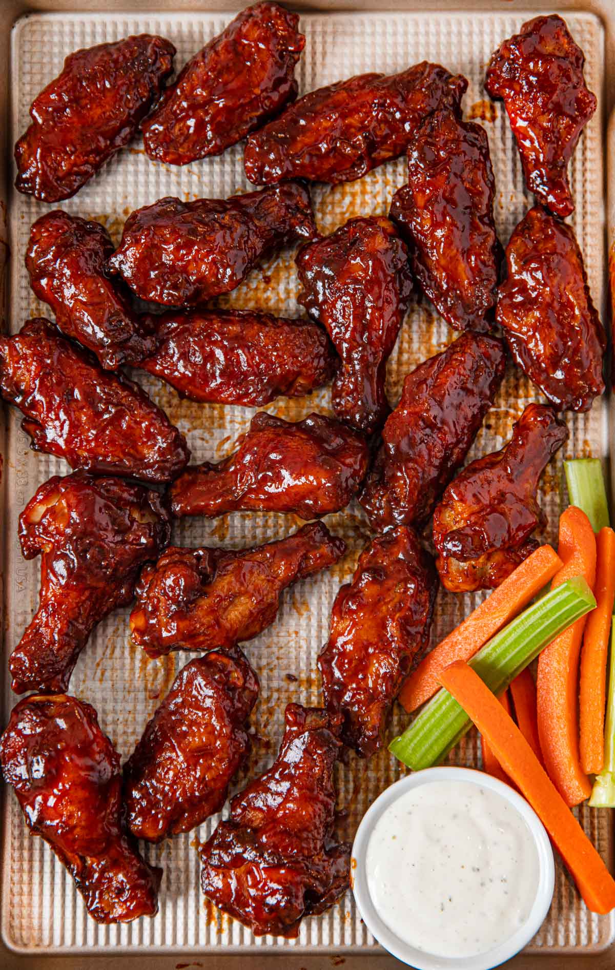 BBQ Chicken Wings with Ranch Dressing and Vegetables on metal tray