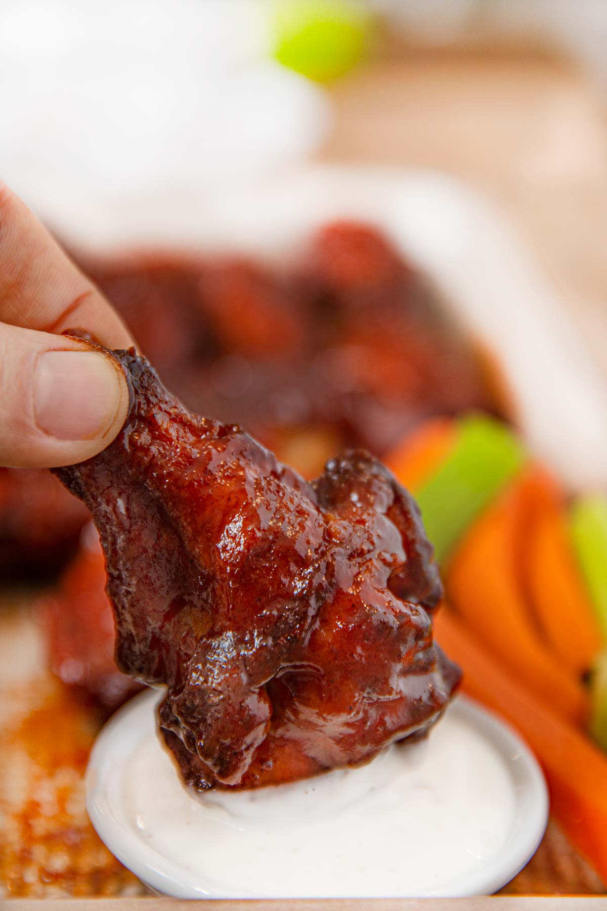 BBQ Chicken Wing being dipped in Ranch Dressing