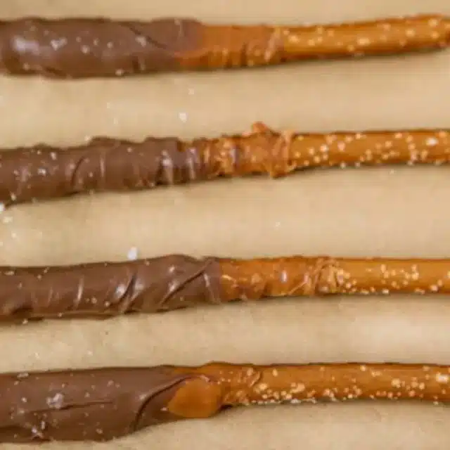 dipped pretzels lined up on parchment paper