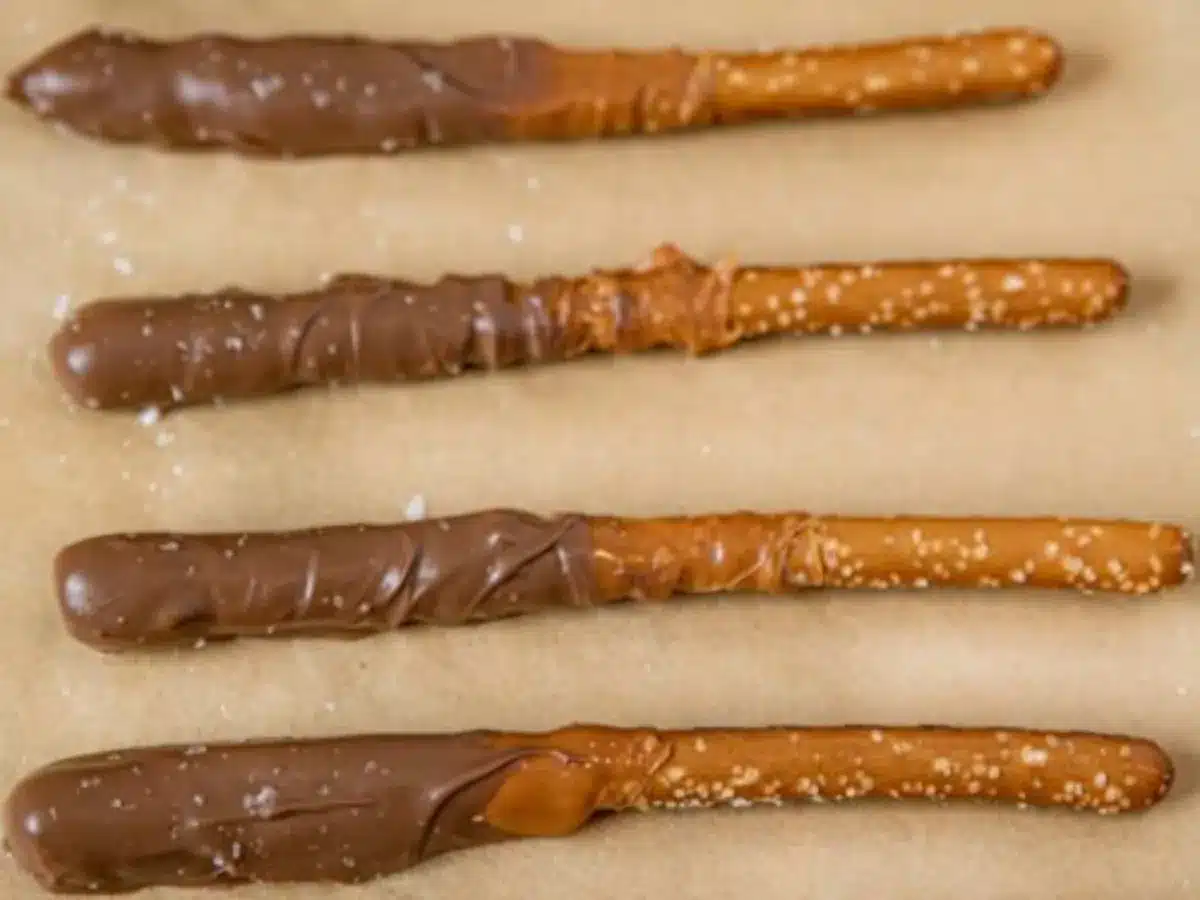 dipped pretzels lined up on parchment paper