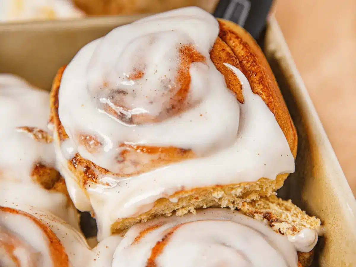 spatula lifting a cinnamon bun