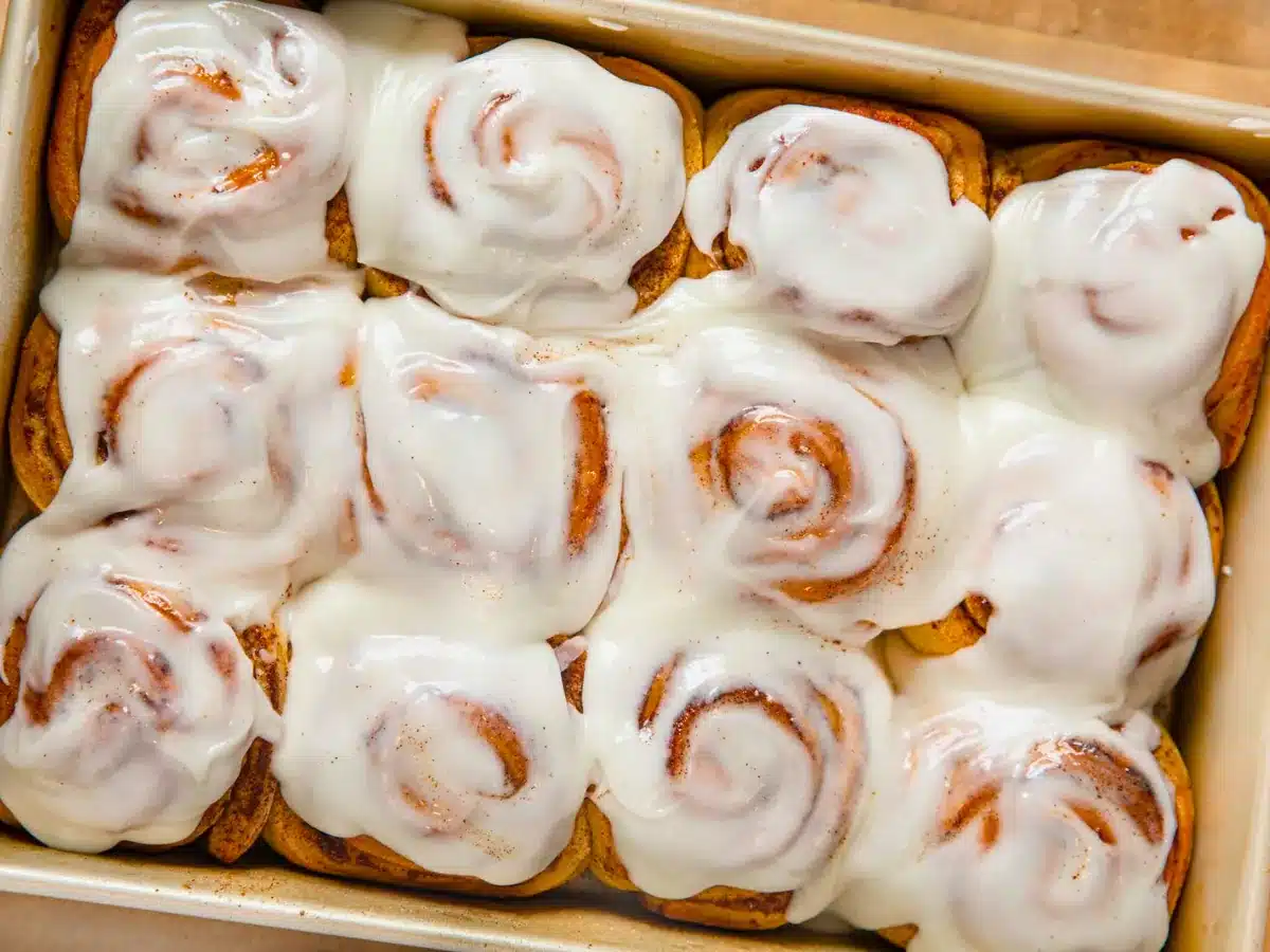 Frosted cinnamon rolls in a pan