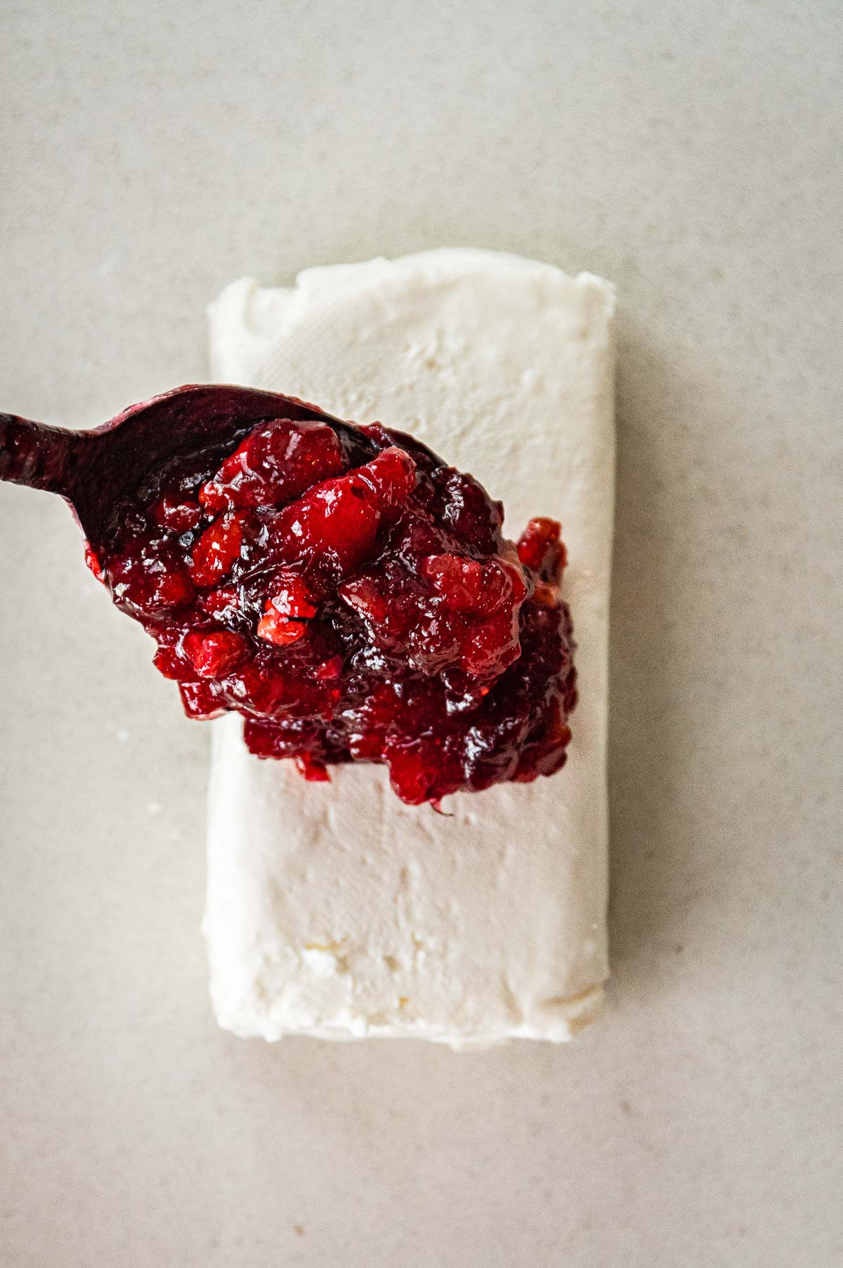 Cranberry Dip spooning over cream cheese