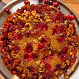 top view of tart berry with nuts inside of cake on silver platter