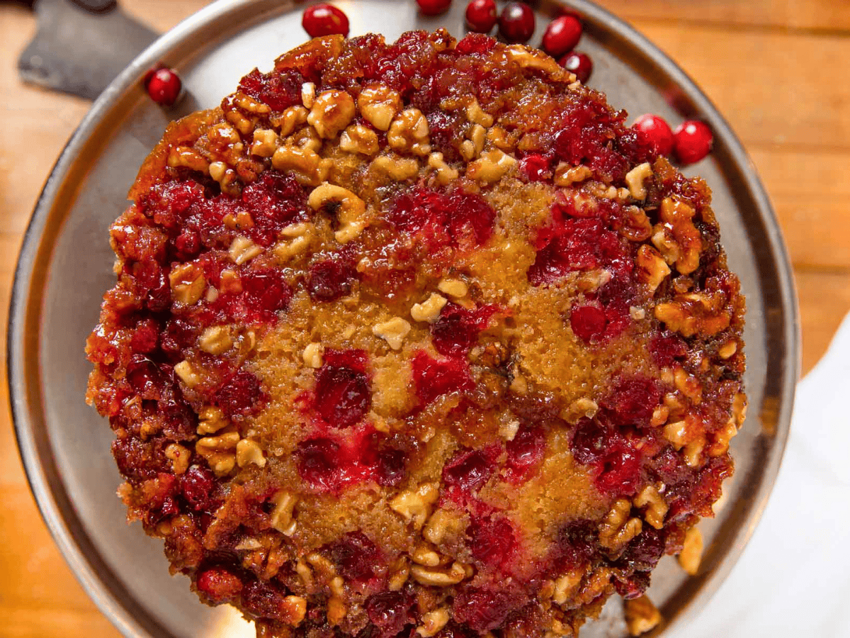 top view of tart berry with nuts inside of cake on silver platter