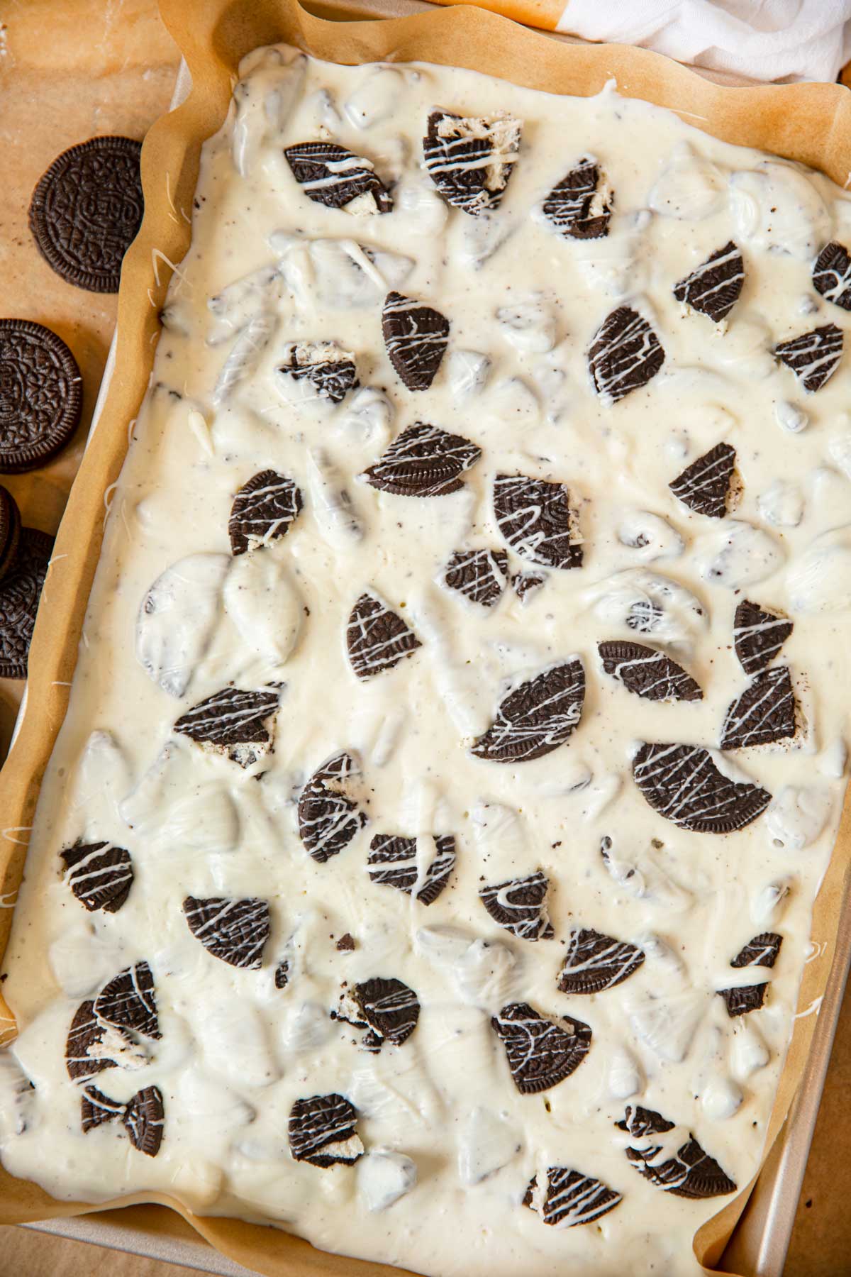 Tray of Oreo Bark with parchment paper on baking sheet