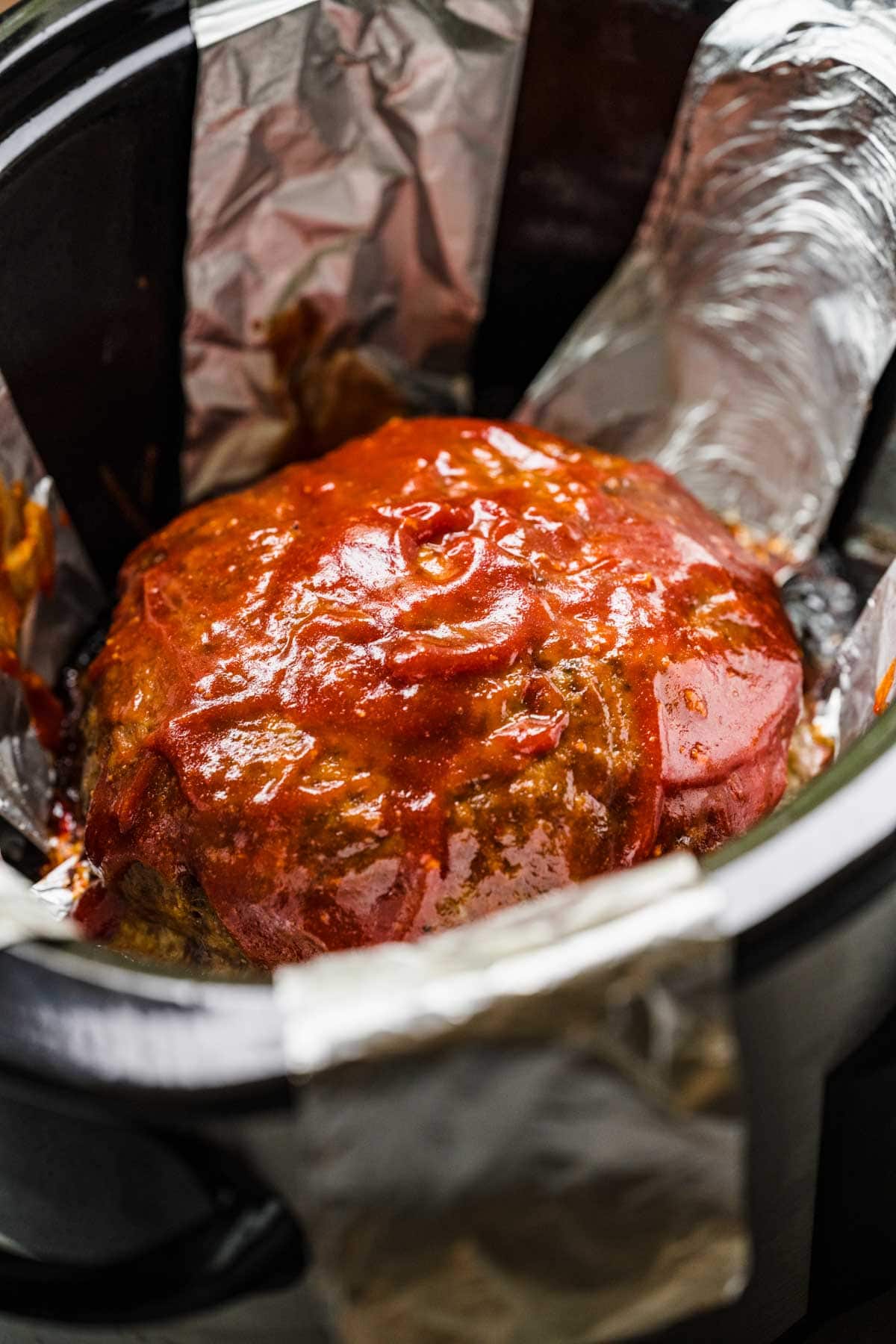 Slow Cooker Meatloaf in cooker after brushing on glaze