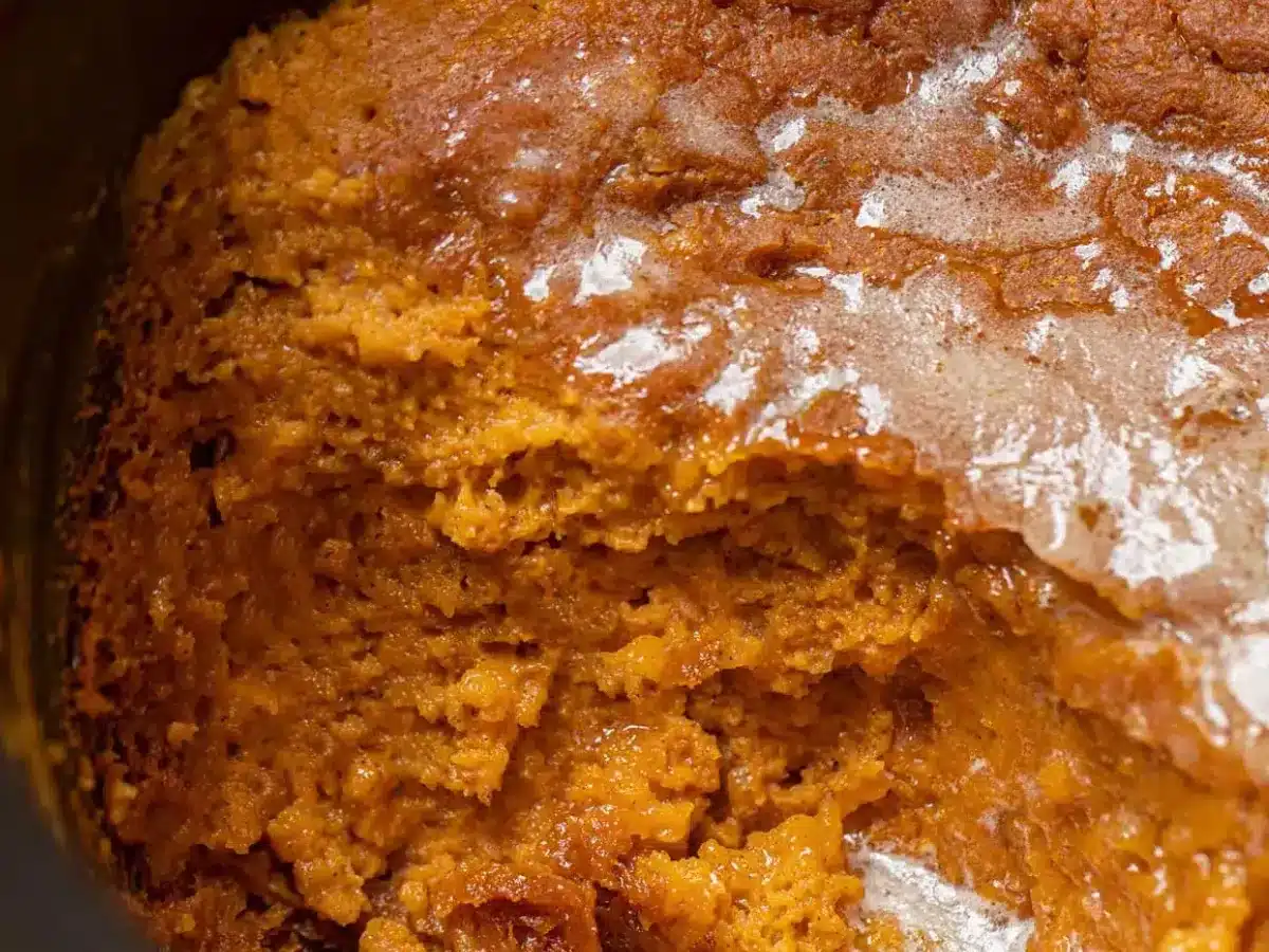 Pudding in slow cooker with scoop taken out