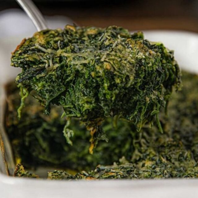 Lifting portion of spinach casserole out of pan