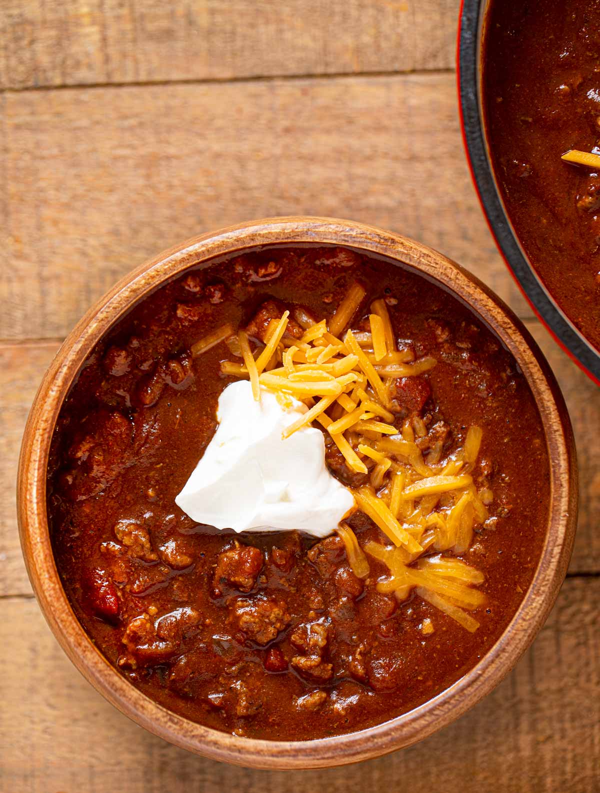 Texas Chili in bowl with sour cream and cheese
