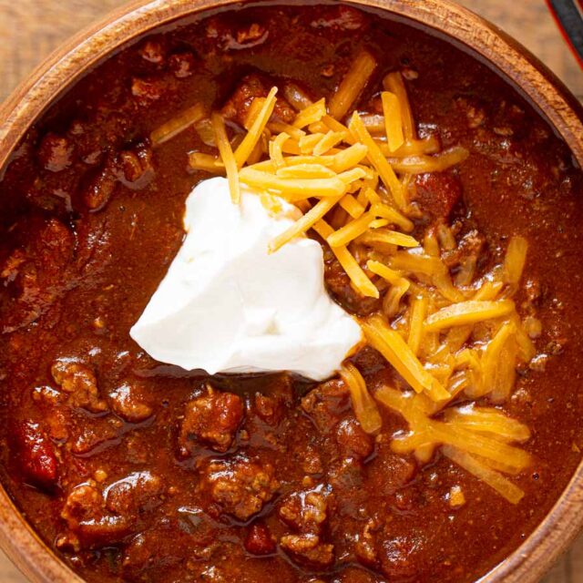 Prepared Chili in bowl topped with sour cream and cheese