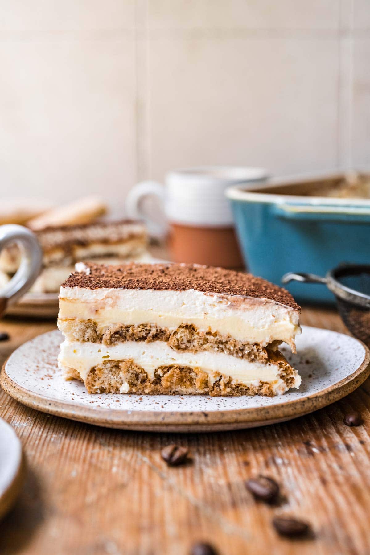 Tiramisu sliced on a whote plate.