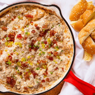 beef, bacon, cheese, dip in a skillet with bread on the side