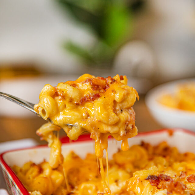 Bacon Mac and Cheese being scooped out of a pan