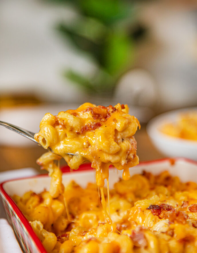 Bacon Mac and Cheese being scooped out of a pan