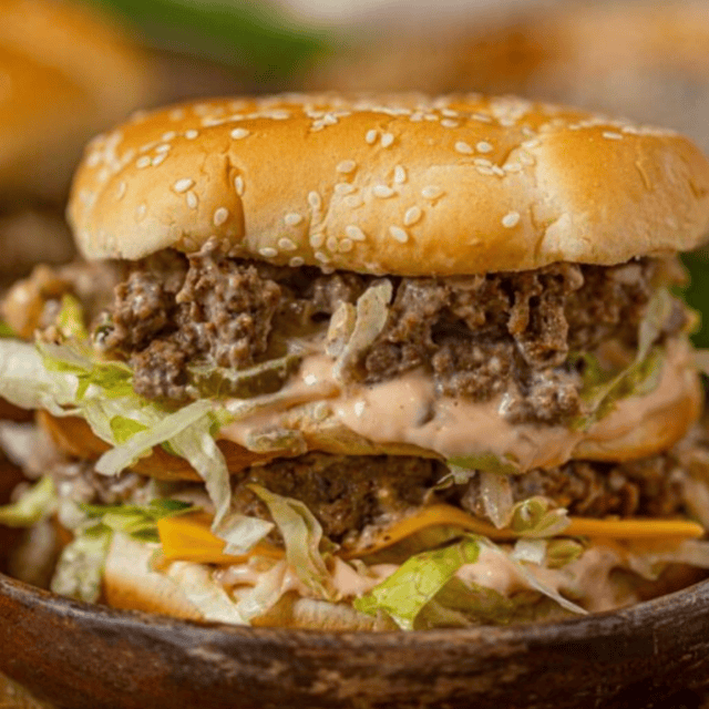 sloppy joe meat in a bun on a wooden plate