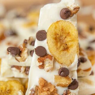 A piece of bark with chocolate chips, and bananas