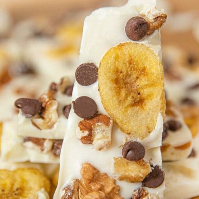 A piece of bark with chocolate chips, and bananas