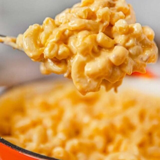 KFC Mac and Cheese in a bowl with a spoon with mac and cheese viewed up close
