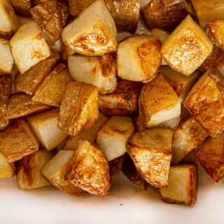 cut potatoes in baking pan with salt