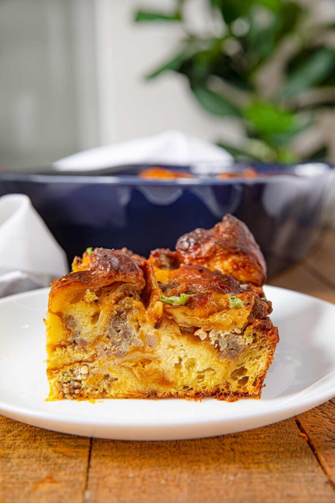 Sausage, Egg and Cheese Breakfast Casserole with Croissants on a white plate