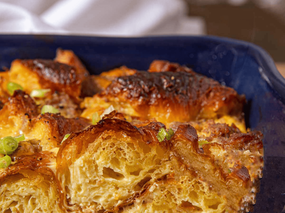 Closeup of baked breakfast ingredients in a blue baking dish 