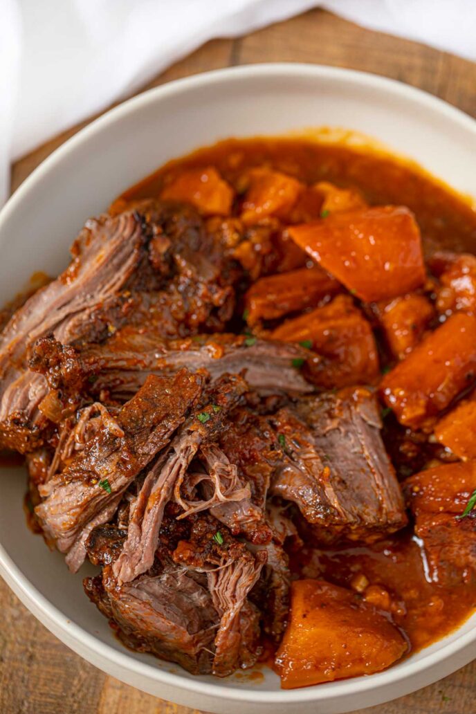 Crockpot Caribbean Pot Roast, Sweet Potatoes and Carrots in a bowl with gravy