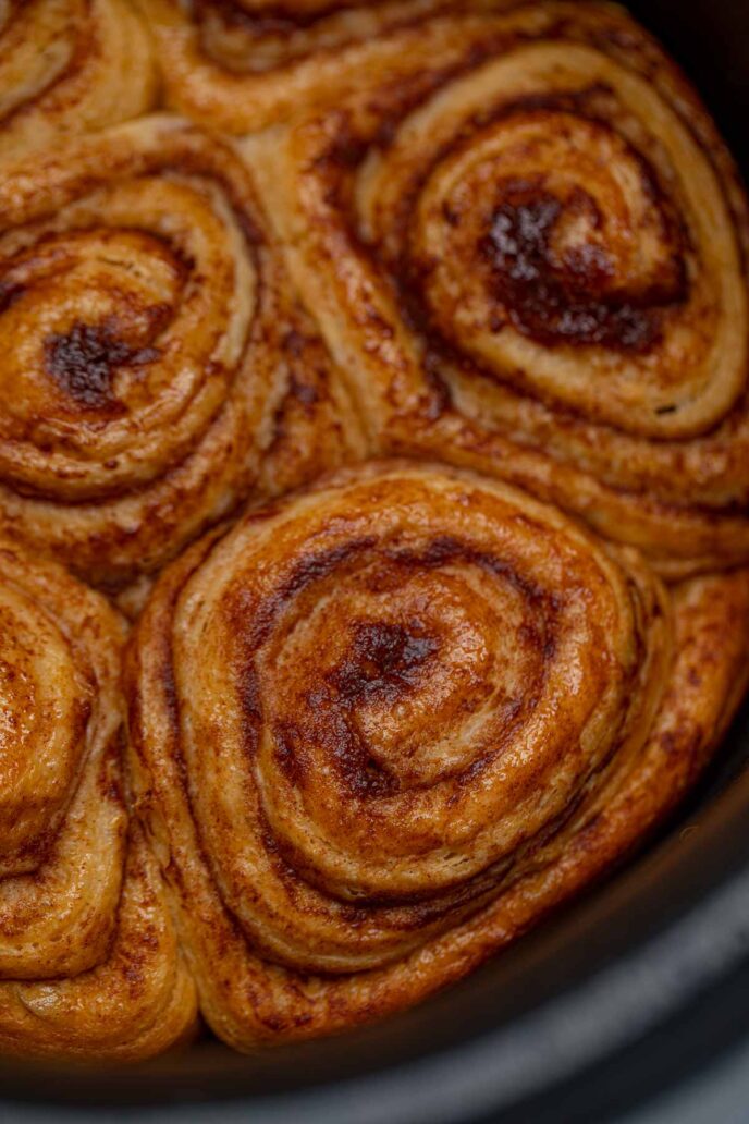 Crockpot cinnamon roll in crockpot without icing