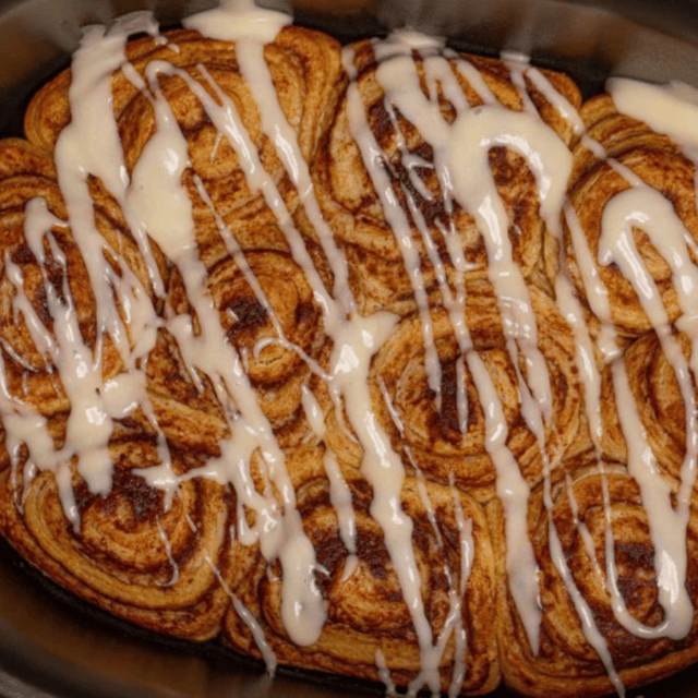 cinnamon sugar rolls in crockpot with icing