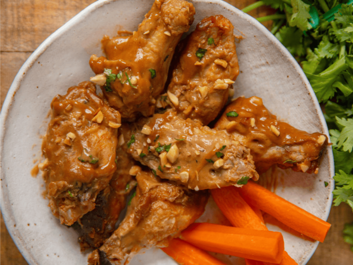 Chicken wings on plate with carrots