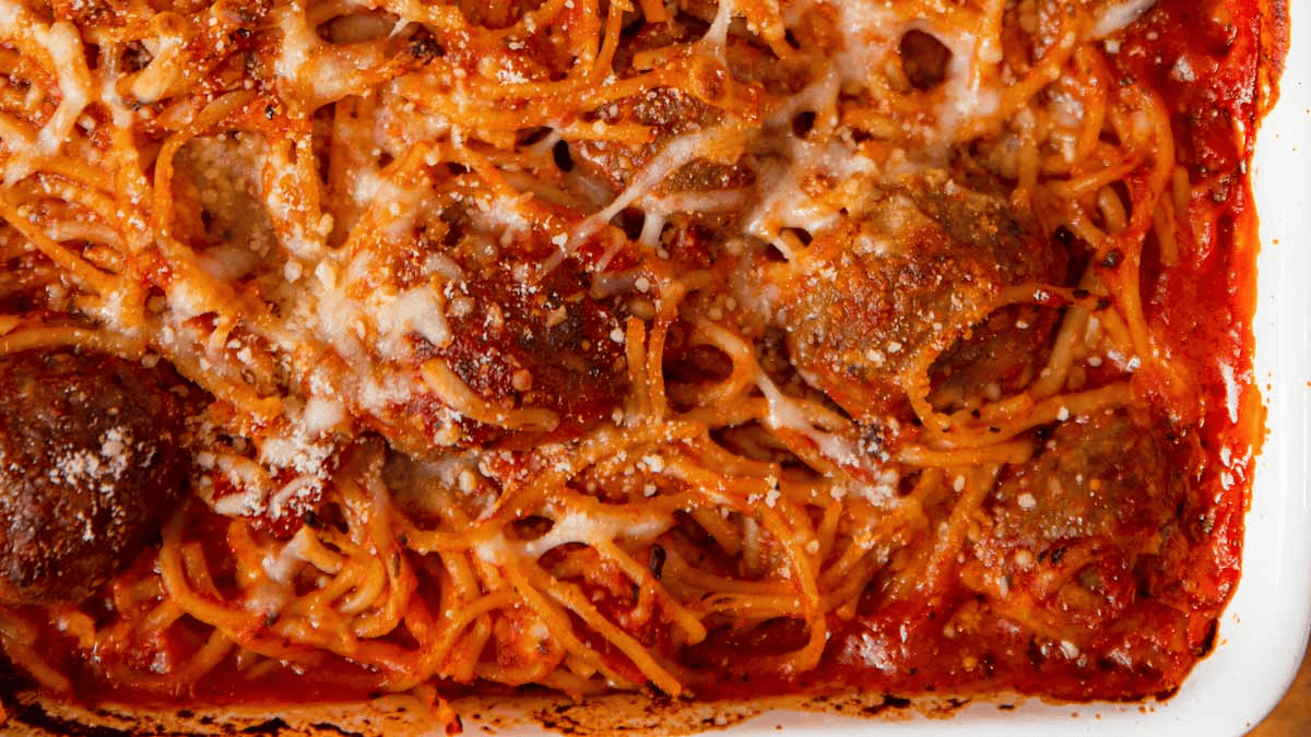 Section of baked spaghetti in a casserole pan