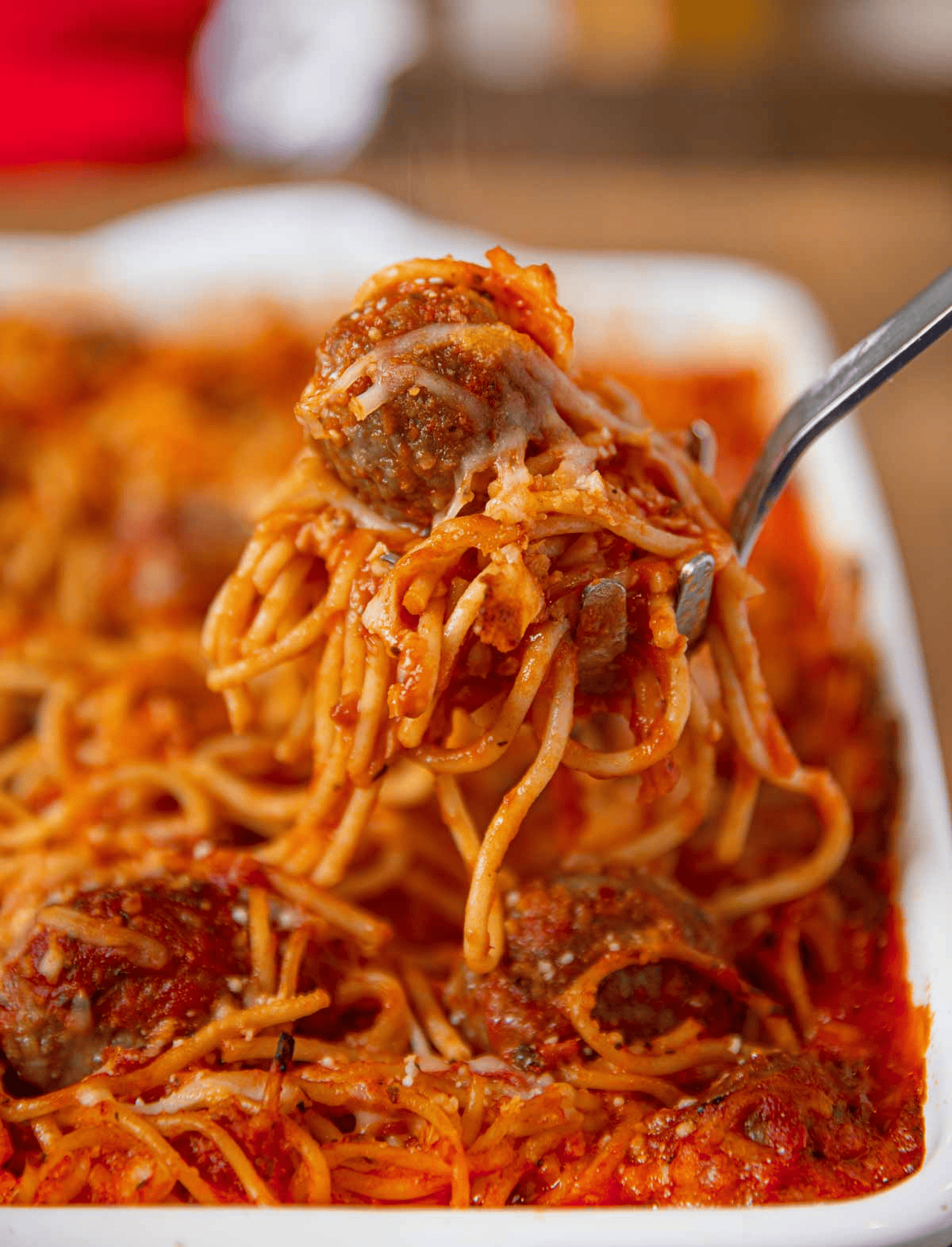 serving spaghetti and meatballs from a baking dish