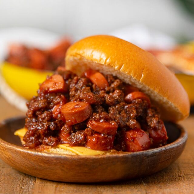 Assembled beef sloppy joe sandwich on plate.