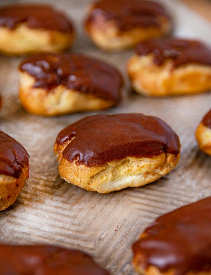 Chocolate Eclairs on baking sheet lined up