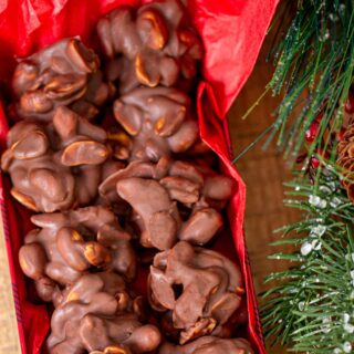 Chocolate Peanut Clusters lined up in a long rectangle decorative box
