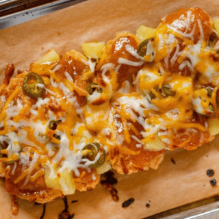 nuggets topped with sauce, cheese, jalapenos and pineapple