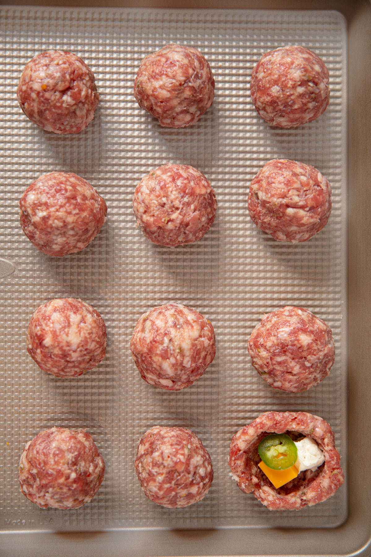 Uncooked meatballs on tray