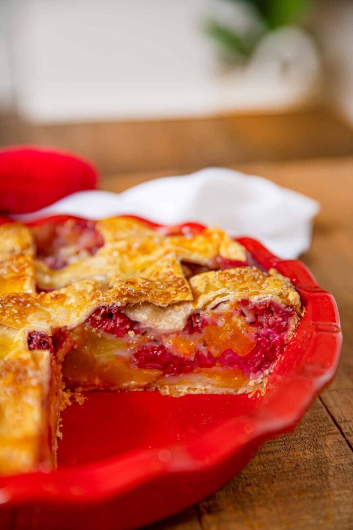 Raspberry Peach Pie sliced in pie plate