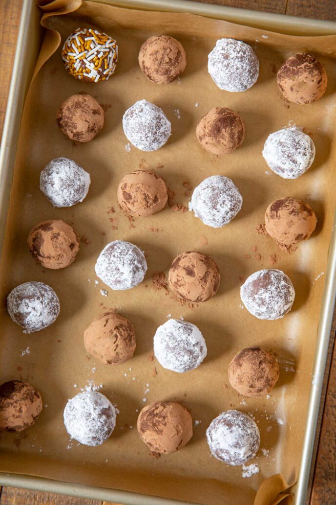 Rum Balls on cookie sheet with assorted coatings