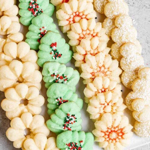 Spritz Cookies with holiday sprinkles on tray