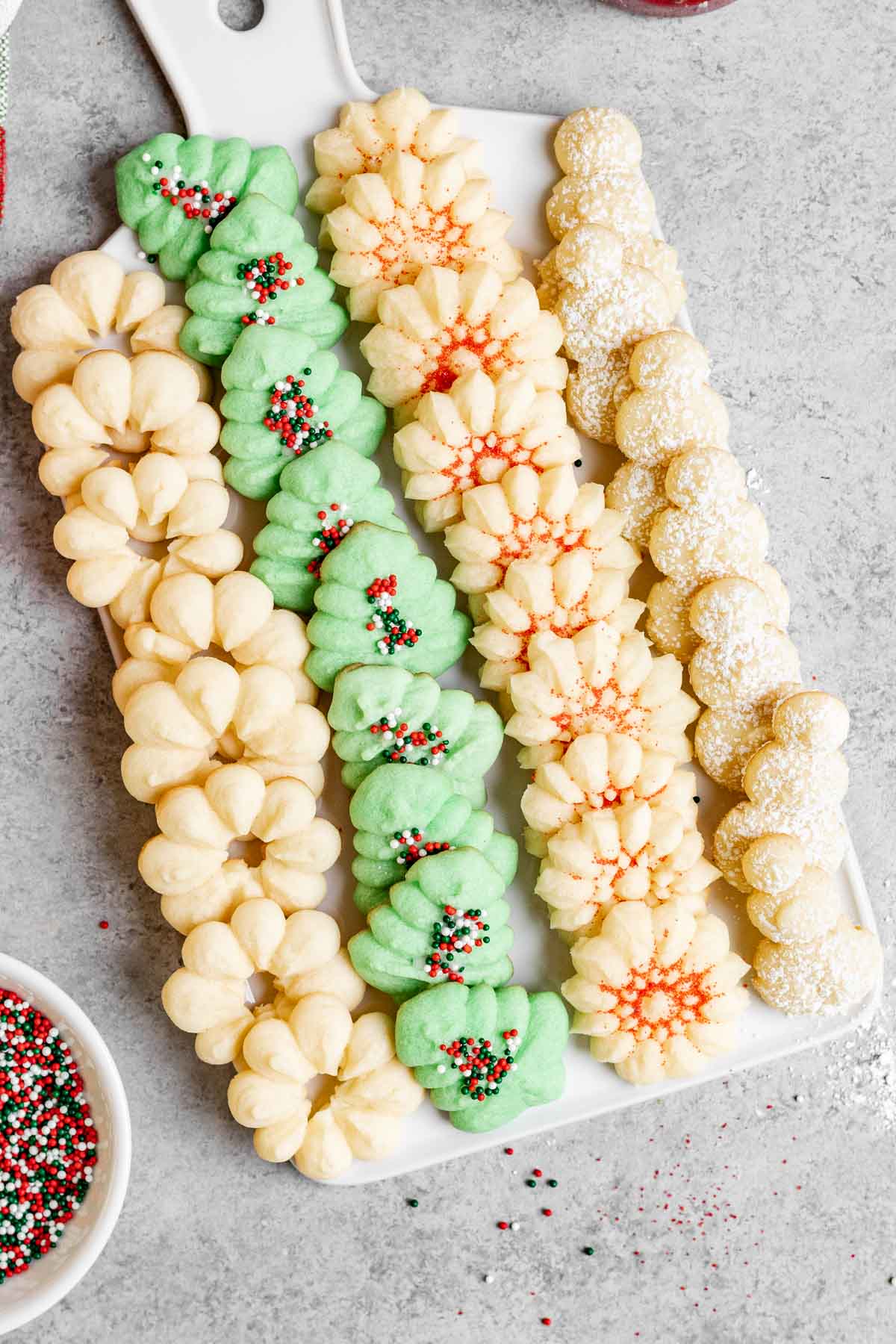 Spritz Cookies with holiday sprinkles on tray