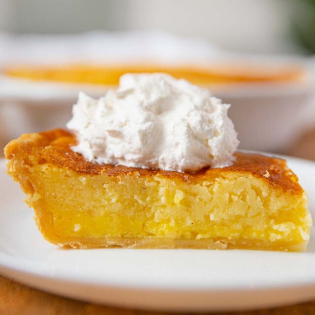 Yellowish slice of dessert on a white plate