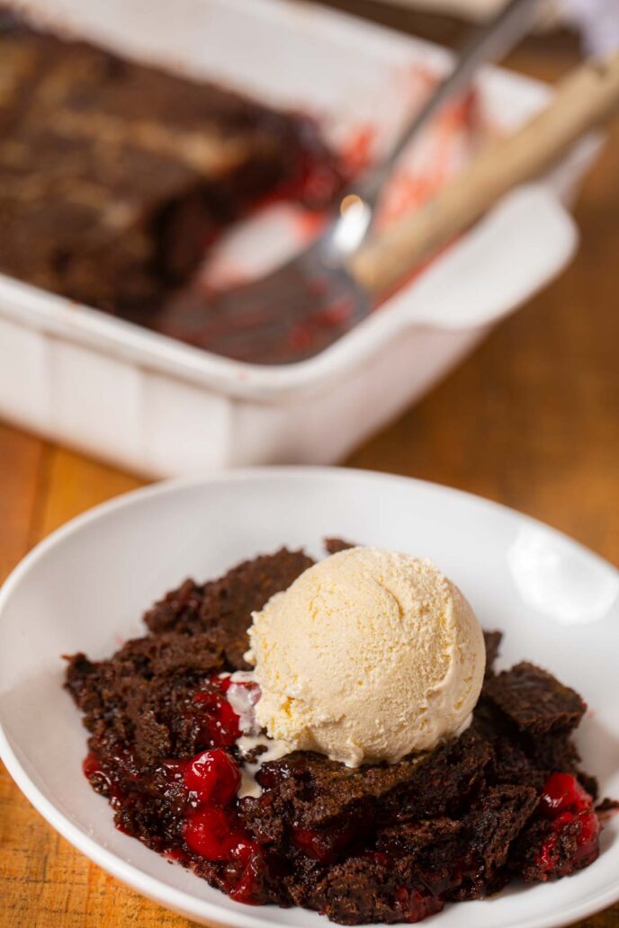 Cherry Chocolate Dump Cake served on plate in front of baking dish