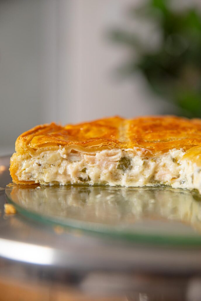 Chicken and Spinach Pie cut in half on cake stand