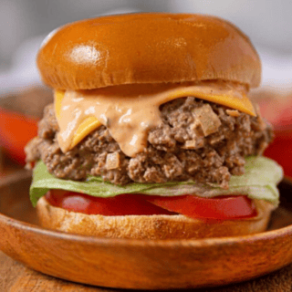 sloppy joes with all the toppings on a wooden plate