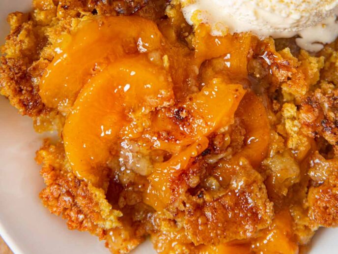 Peach Crisp serving on plate with vanilla ice cream